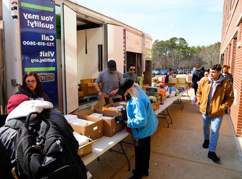 Helping hands food pantry and Fulfill food bank giving food donations to students